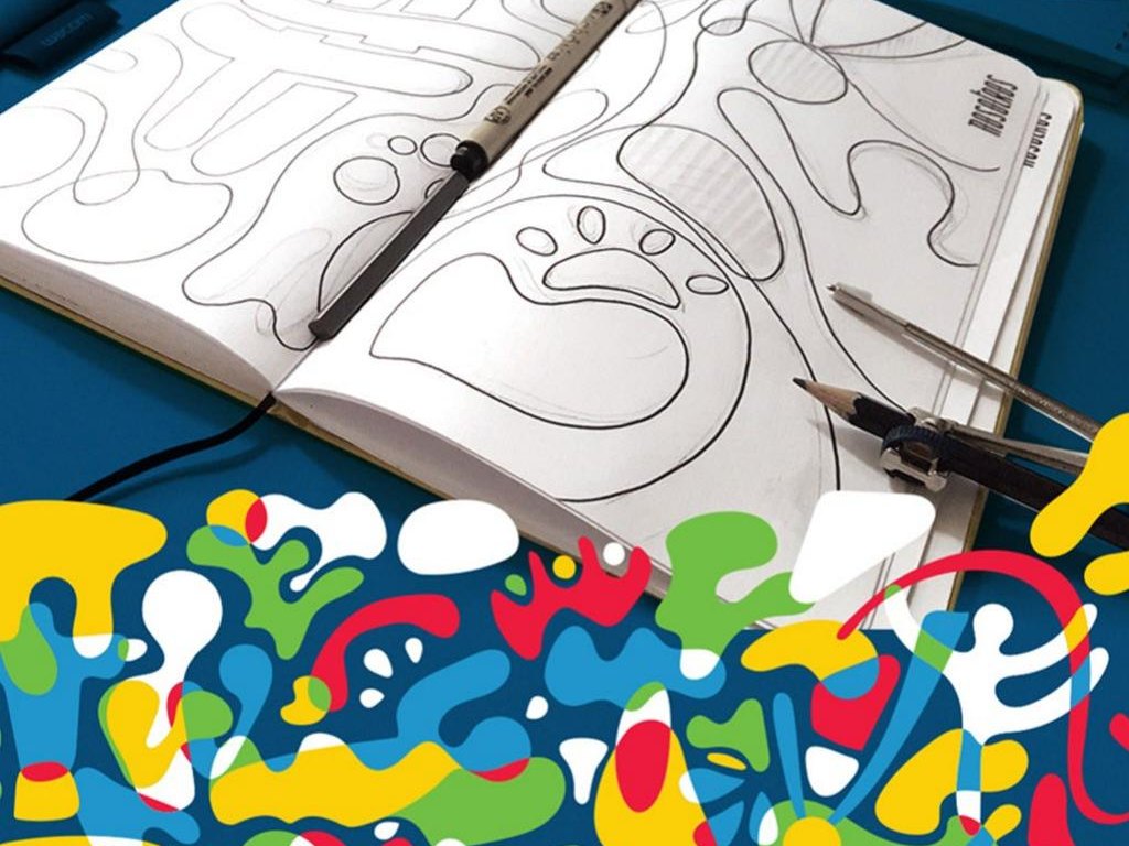 Hand sketches of the identity pattern in a notebook, above the finished pattern