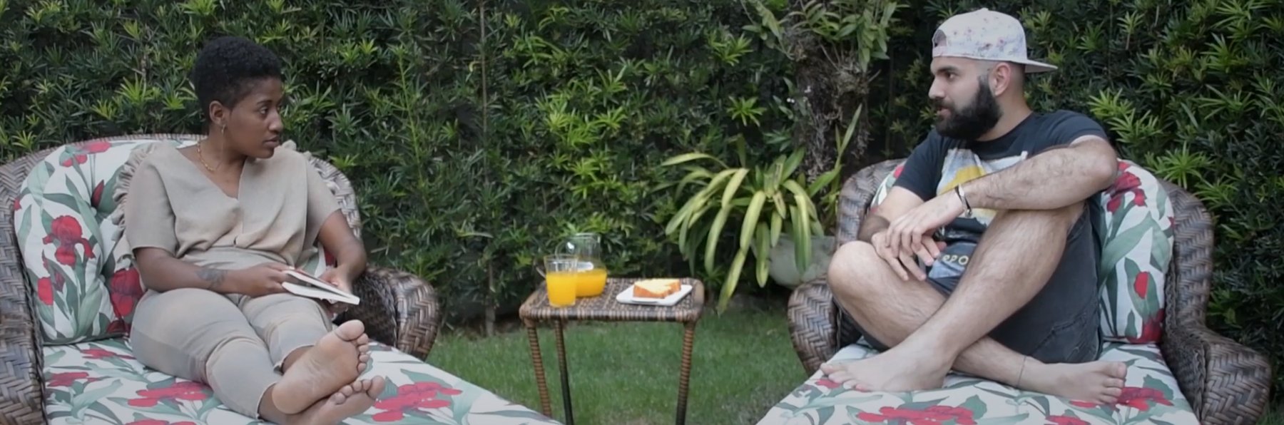 Two participants talking in a garden, from the video series