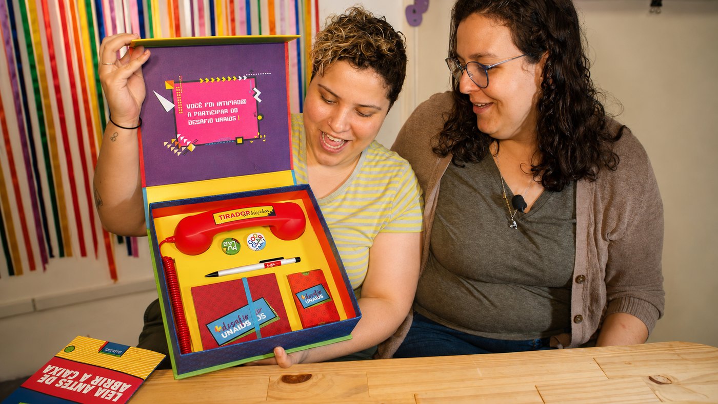 Two participants opening the box together